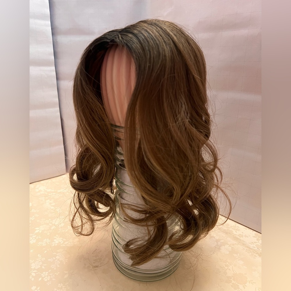 Full coverage medium brown wig with blonde highlights.
